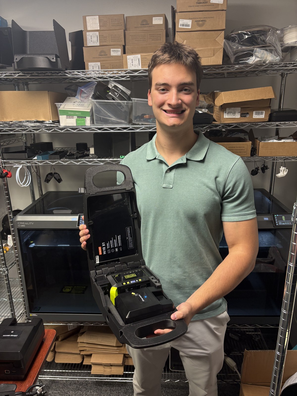 Ronan holding the open portable IDentiFake prototype in the TokenWorks workshop